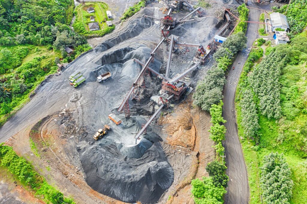pexels-photo-2101140 Aerial shot of a mining site surrounded by greenery, showcasing industrial activity.