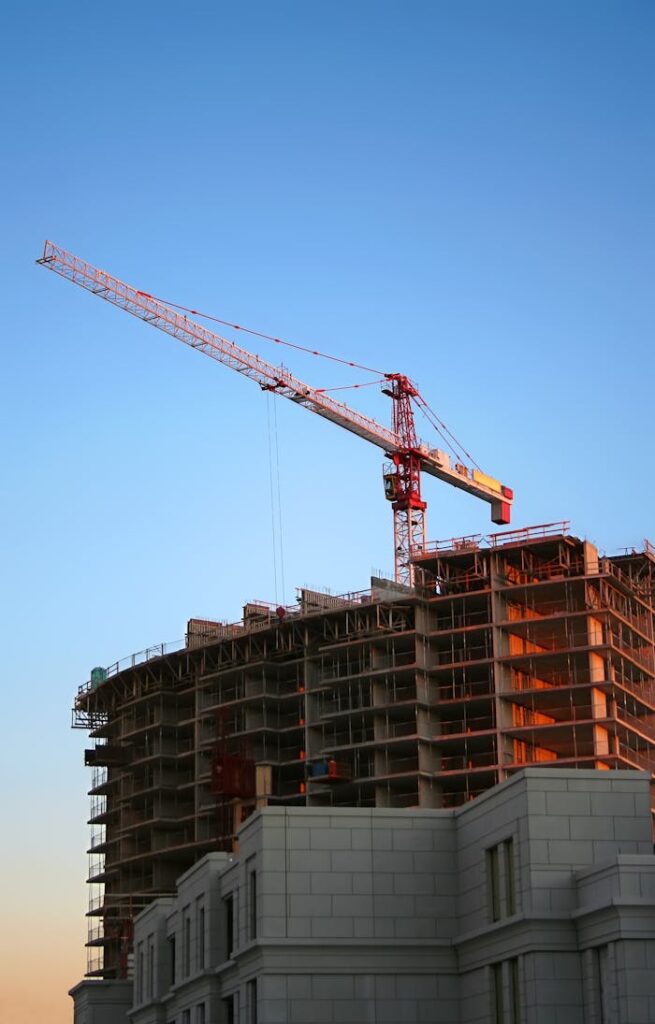 pexels-photo-93400 Tower crane on a high-rise building under construction at sunset, showcasing modern urban development.